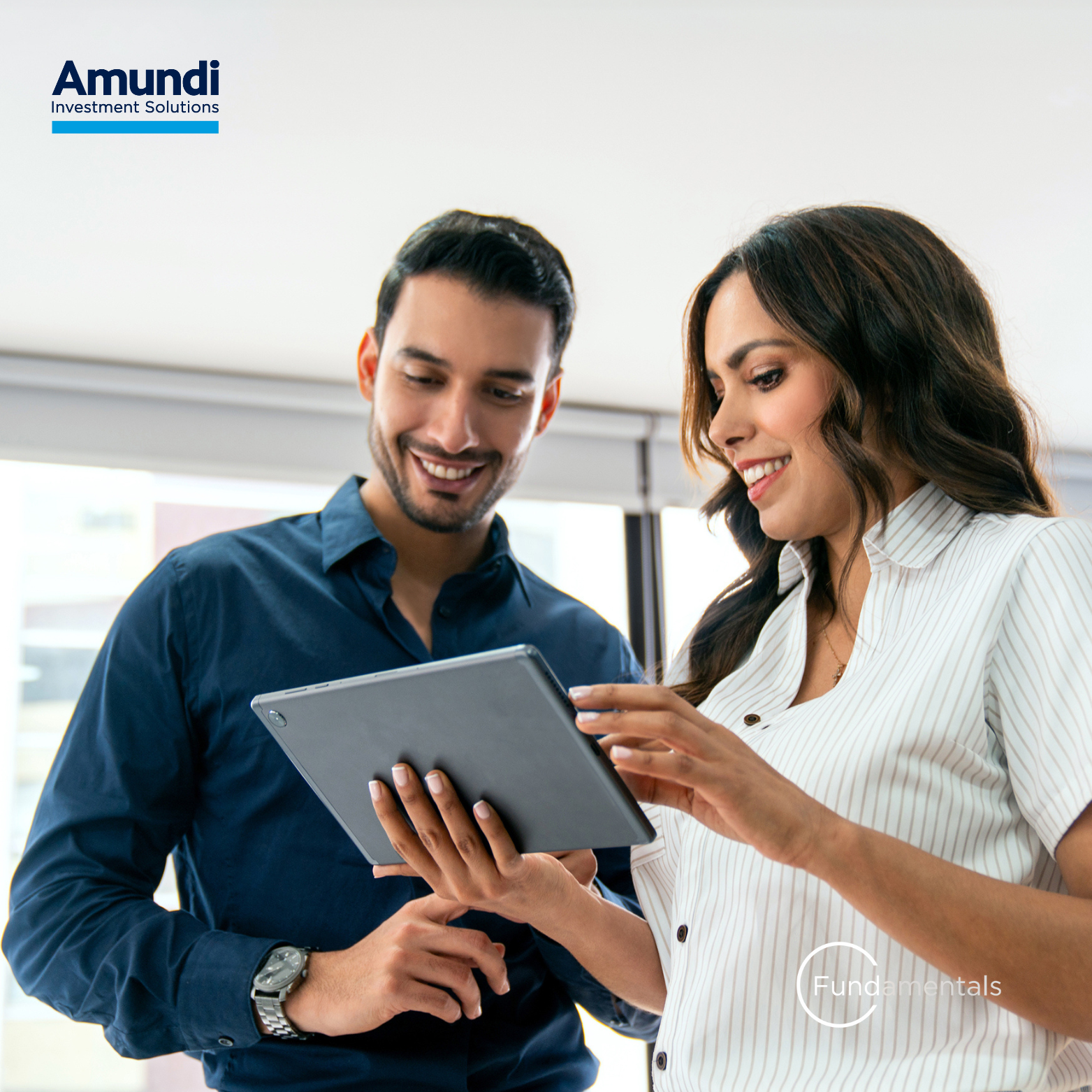 A man and a woman looking at a tablet