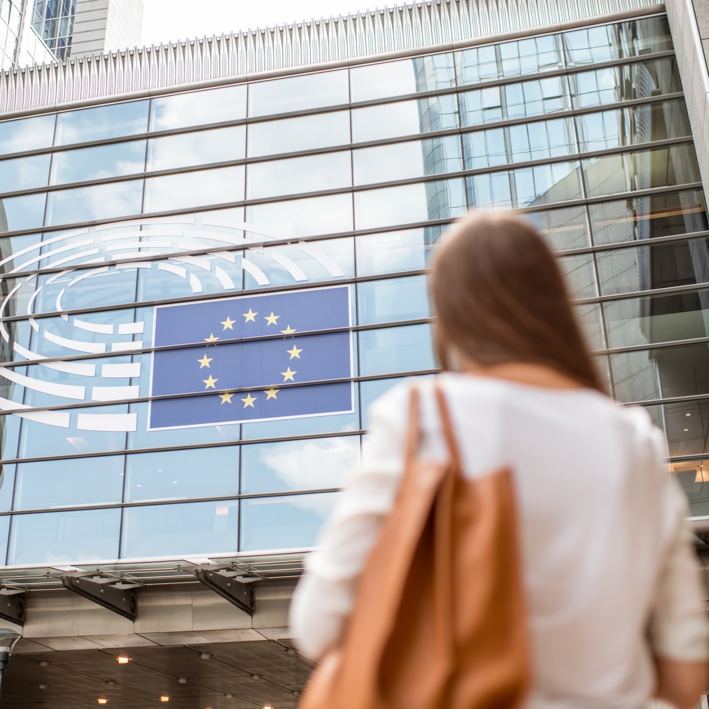 woman walking in front of European building