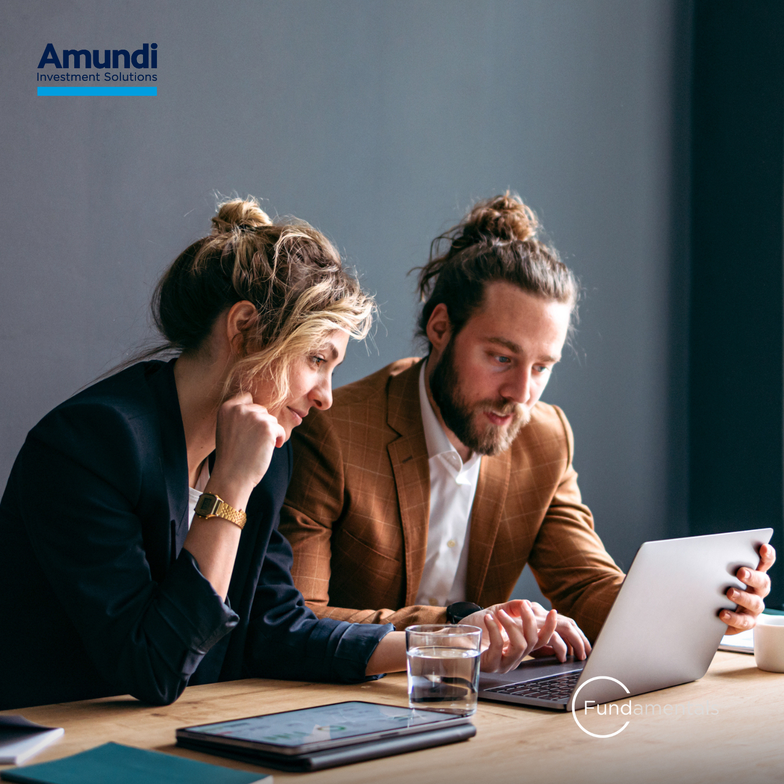 A man and a woman in front of a computer